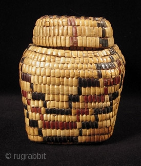 Fully imbricated lidded basket.
Native American, Columbia River.
Reeds, cedar bark.
9" wide by 3" high (23 by 7.5 cm).
Last quarter 19th century.             