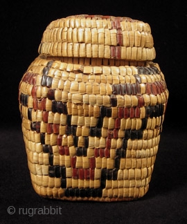 Fully imbricated lidded basket.
Native American, Columbia River.
Reeds, cedar bark.
9" wide by 3" high (23 by 7.5 cm).
Last quarter 19th century.             