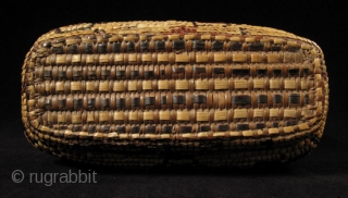 Fully imbricated lidded basket.
Native American, Columbia River.
Reeds, cedar bark.
9" wide by 3" high (23 by 7.5 cm).
Last quarter 19th century.             