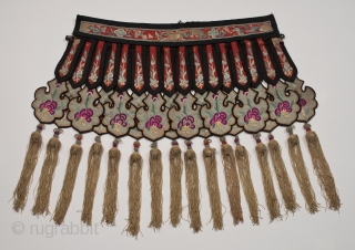 Cloud collar, China. Silk and cotton. 19th - 20th century. 15" (38 cm) from edge of collar to tip of fringe. Neck band is 15.5" (39.4 cm) long. Some areas of fraying  ...