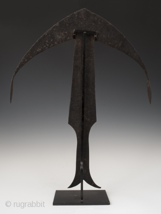 Anchor currency, zong,
Kwele people, Gabon/Democratic Republic of Congo.
Hand forged iron,
21.75" (55.3 cm) high as based and 16" (40.6 cm) wide.
Early to mid 20th century.

Inspired by a crossbow and mandjong, these anchor-like currencies  ...