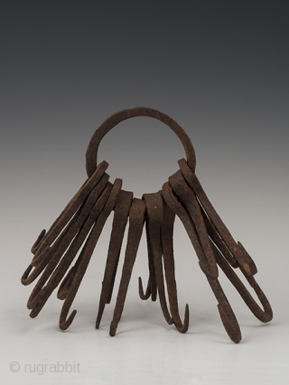 Ring of double hooks,
possibly West Africa.
Hand forged iron,
8" (20.2 cm) high,
Early to mid 20th century.

This might be an unusual type of currency or utilitarian object.        