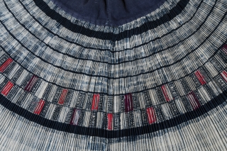 Pleated skirt,
Miao people, China.
Cotton, silk.
Mid-20th century.
18" long by 38.5" wide at waistband.
Skirt is open at the side, with the pleats joined to a wide cotton waistband. The designs are wax-resist in indigo  ...