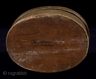 Bentwood box,
America,
Wood, paint.
5.5" (14 cm) wide, 2" (5 cm) high.
19th century.
Oval bentwood box with finger joint construction has a tromp l'oeil painting on a green ground. The bottom is signed Joe Watson  ...