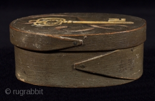 Bentwood box,
America,
Wood, paint.
5.5" (14 cm) wide, 2" (5 cm) high.
19th century.
Oval bentwood box with finger joint construction has a tromp l'oeil painting on a green ground. The bottom is signed Joe Watson  ...