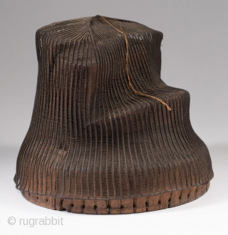 Tanggeon with base,
Korea.
Horsehair, wood,
21" (53.3 cm) in circumference, 6" (15.2 cm) high.
Late 19th to early 20th century.
The tanggeon was worn by nobility, as well as men in the commercial and medical fields.  ...