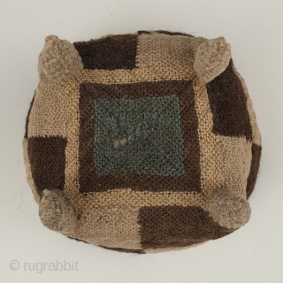 Four-cornered hat, Huari culture, Peru. Camelid fibers, natural dye.
A.D. 700-1000, 5.25" (13.3 cm) high by 5.75" (14.6 cm) diameter.
Ex. Fifi White collection, California. 	

An unusual brown and tan checkerboard four-cornered hat with  ...