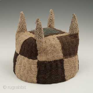 Four-cornered hat, Huari culture, Peru. Camelid fibers, natural dye.
A.D. 700-1000, 5.25" (13.3 cm) high by 5.75" (14.6 cm) diameter.
Ex. Fifi White collection, California. 	

An unusual brown and tan checkerboard four-cornered hat with  ...