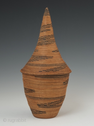 Presentation basket (Igiseke), Tutsi people, Rwanda. Plant fibers, natural dye. 8.75" (22.2 cm) high by 4" (10 cm) wide. Mid 20th century, ex. private collection, New York.

Baskets such as this often contained  ...