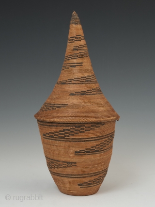 Presentation basket (Igiseke), Tutsi people, Rwanda. Plant fibers, natural dye. 8.75" (22.2 cm) high by 4" (10 cm) wide. Mid 20th century, ex. private collection, New York.

Baskets such as this often contained  ...