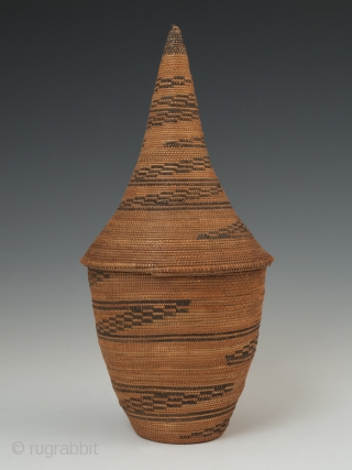 Presentation basket (Igiseke), Tutsi people, Rwanda. Plant fibers, natural dye. 8.75" (22.2 cm) high by 4" (10 cm) wide. Mid 20th century, ex. private collection, New York.

Baskets such as this often contained  ...