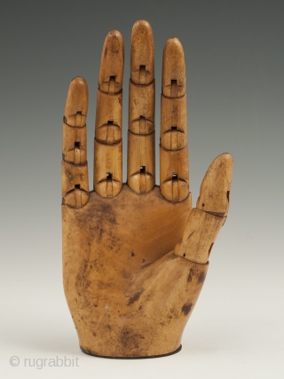 An expressive articulated carved wood mannequin hand, likely made in France. It measures 7" (17.7 cm) high by 3" (7.6 cm) wide. Late 19th to early 20th century.

     