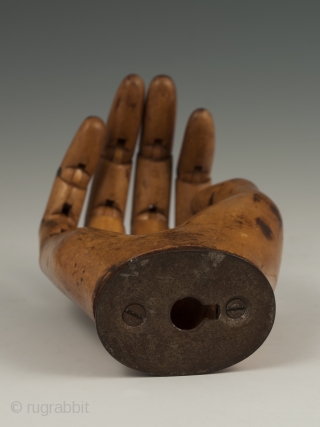 An expressive articulated carved wood mannequin hand, likely made in France. It measures 7" (17.7 cm) high by 3" (7.6 cm) wide. Late 19th to early 20th century.

     