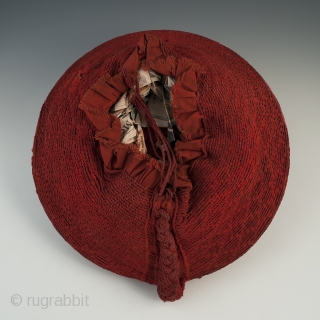 Woman's hat, Isicholo, Zulu people, South Africa. Cotton, wire, 11" (28 cm) in diameter by 3" (7.6 cm) high, Mid 20th century.
The unusual spiral weave on this cotton Isicholo makes this a  ...