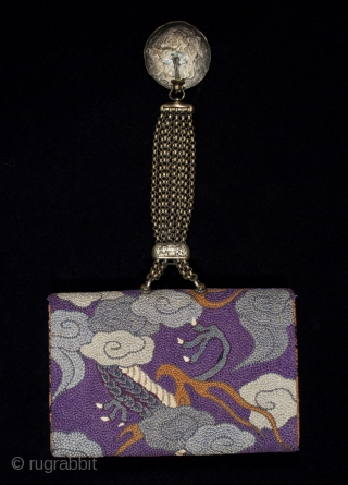 Tobacco pouch,
Japan.
Leather, silk, metal.
5.5" (14 cm) wide by 3.5" (9 cm).
Meiji Period 1868-1912.
This tobacco pouch is covered in French-knotted silk, depicting a writhing dragon grasping a pearl as he flies through the  ...