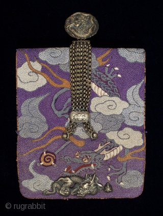 Tobacco pouch,
Japan.
Leather, silk, metal.
5.5" (14 cm) wide by 3.5" (9 cm).
Meiji Period 1868-1912.
This tobacco pouch is covered in French-knotted silk, depicting a writhing dragon grasping a pearl as he flies through the  ...
