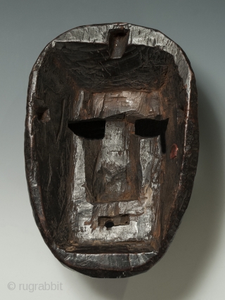 Mask, Middle Hills, Nepal. Wood, 9″ (22.8 cm) high by 6″ (15.2 cm). Early 20th century. A Middle Hills mask with several unusual markings: a trisula carved into the forehead, white painted  ...