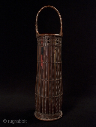 Ikebana basket,
Japan,
Bamboo, split arrows,
22" (56 cm) high,
Taisho Period,
Chikunsai III, b.1940, was known for using split arrows in his baskets, as can be seen in the painted bamboo. He is the grandson of  ...