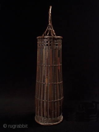 Ikebana basket,
Japan,
Bamboo, split arrows,
22" (56 cm) high,
Taisho Period,
Chikunsai III, b.1940, was known for using split arrows in his baskets, as can be seen in the painted bamboo. He is the grandson of  ...