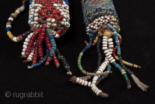 Beaded lime containers,
Timor Island, Indonesia,
Seed beads, cork, string
2.75 " (14.6 cm) and 3" (19.6 cm) high.
Early to mid 20th century. Sold separately           