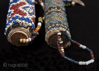 Beaded lime containers,
Timor Island, Indonesia,
Seed beads, cork, string
2.75 " (14.6 cm) and 3" (19.6 cm) high.
Early to mid 20th century. Sold separately           