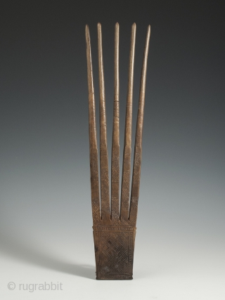 Horn Comb, Timor Island, 11.75" (30 cm) high by 3" (7.5 cm) wide, early 20th century. This five-pronged carved horn comb is notable for its large size and has a smooth patina  ...