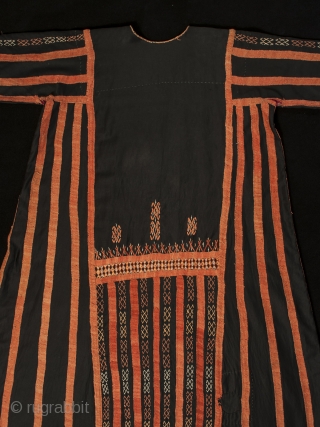 A traditional dress worn by women in the Western Desert of Egypt, this fustan is ornately decorated with thin silver coins, buttons and very fine cotton embroidery. There is a pocket on  ...