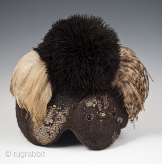 Emedot Headdress,
Karamojong tribe, Uganda/Kenya.
Feathers, felted human hair, clay, wire, aluminum rings,
20th century.
8.5" (21.6 cm) high by 7.5" (19 cm) wide by 6.5" 16.5 cm) deep
Ex. Merton D. Simpson
Catalog notes: "Amoung a selection  ...