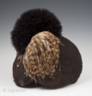 Emedot Headdress,
Karamojong tribe, Uganda/Kenya.
Feathers, felted human hair, clay, wire, aluminum rings,
20th century.
8.5" (21.6 cm) high by 7.5" (19 cm) wide by 6.5" 16.5 cm) deep
Ex. Merton D. Simpson
Catalog notes: "Amoung a selection  ...