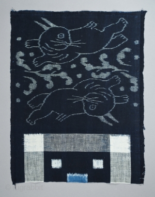 Double ikat futonji (futon cover fragment), Japan. Hand loomed cotton, indigo,
13"(33 cm) by 16.5" (42 cm), 
Late 19th to early 20th century,
Ex Fifi White, Berkeley, California, excellent condition.
Two rabbits from Japanese folklore,  ...
