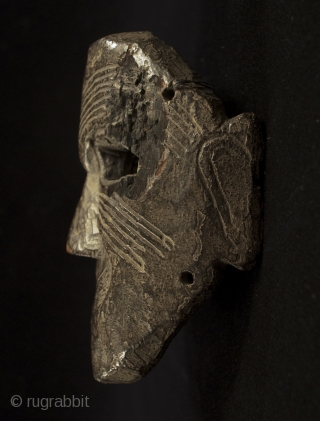 Mask, Middle Hills, Nepal. 7" (18 cm) high by 5.5" (14 cm) wide. 18th century or earlier. A powerful piece with a little charred area near the right eye.    