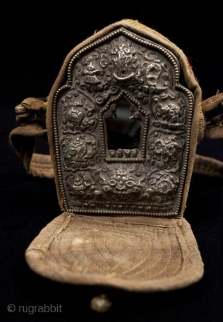 Gau prayer box, Tibet, with a small ceramic figure on the inside of the back panel. It can be seen through the glass window. These were worn while traveling or kept in  ...