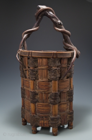 Ikebana basket,
Japan.
Split bamboo, mulberry bark, twisted branch and vine.
Showa Period,
20.5" (52 cm) high by 11" (28 cm) wide               