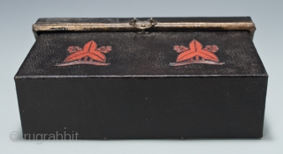 Carrying box,
Japan.
Leather, wood, metal.
Late 19th century,
8" (20.2 cm) wide by 4.5" (11.4 cm) high by 2.5" (6.3 cm) deep.
This mysterious little box was used as a carrying case for small cylindrical objects,  ...