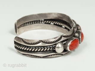 20th Century Coral and Silver Bracelet by Fred Thompson, Navajo Jeweler. Five gorgeous cabochons of rich red coral are set in silver bezels, flanked by silver beads and stamped crescents, in this  ...