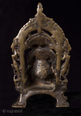 Kubera, India.
Lost wax cast bronze.
5 1/2" (14 cm) high.
13-16th century.

This is a small portable bronze shrine of Kubera, the god of riches and guardian of the north. He is short and portly  ...