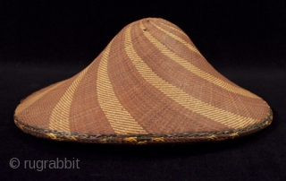Salakot hat, Philippines. Woven rattan. 16" high by 13" wide, as shown in first photo. 19th-20th century. There are some small spots of loss along the edge and on the underside as  ...