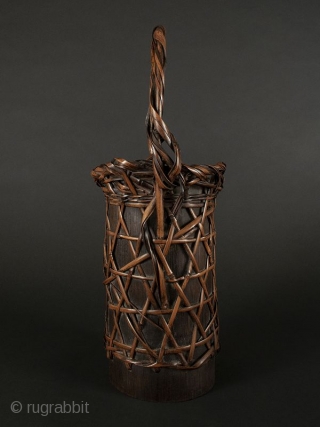 Japanese Antique Bamboo Flower Basket

Japanese antique bamboo flower basket, cylindrical shaped with open weave with a criss cross design. Body open to expose bamboo container. Handle has twisted bamboo strands attached at  ...