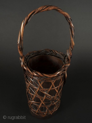 Japanese Antique Bamboo Flower Basket

Japanese antique bamboo flower basket, cylindrical shaped with open weave with a criss cross design. Body open to expose bamboo container. Handle has twisted bamboo strands attached at  ...