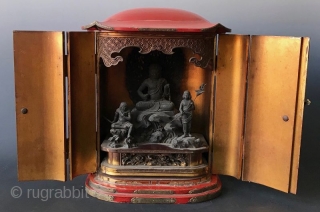 Japanese Red Lacquer Zushi Traveling Buddhist Shrine
Japanese Buddhist Zushi (portable shrine) with bright red lacquered wood exterior and gilt interior. Shrine with the statue of sitting Fudo Myoo, the fierce deity with  ...