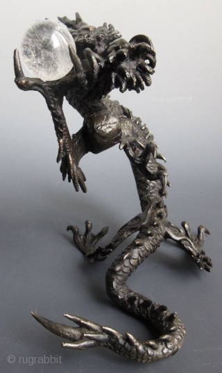 Japanese Bronze Dragon with Crystal Ball
Japanese bronze sculpture of a coiling dragon, holding a clear quartz crystal ball in its raised claw. The foot is cast with the two character seal of  ...