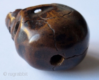 Unusual Antique Japanese Boxwood Skull Ojime
Japanese boxwood ojime bead carving of a skull, finely detailed with realistic cranial fissures, charming missing teeth, pierced eye sockets and nasal cavity, with tiny handmade chisel  ...