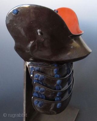 Japanese Hanpo Cheek Guard Armor
Japanese samurai hanpo cheek guard armor. Black lacquered iron with 4 lamellar neck guard, laced with dark blue silk cords. The cheek guard is lacquered in red. Mounted  ...