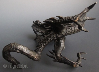 Japanese Bronze Dragon with Crystal Ball
Japanese bronze sculpture of a coiling dragon, holding a clear quartz crystal ball in its raised claw. The foot is cast with the two character seal of  ...