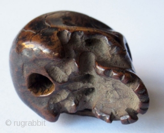 Unusual Antique Japanese Boxwood Skull Ojime
Japanese boxwood ojime bead carving of a skull, finely detailed with realistic cranial fissures, charming missing teeth, pierced eye sockets and nasal cavity, with tiny handmade chisel  ...