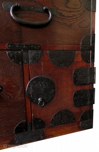 AntiqueJapanese Single Section Burl Keyaki Tansu
Japanese single section clothing tansu, with Kuri burl hardwood front drawers, iron lock plates with foliate edges, warabite pulls, fan-shaped iron corner hardware. The bottom corner has  ...