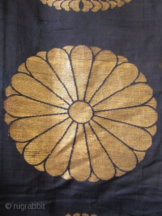 Japanese Antique Large Buddhist Textile Cover

Beautiful antique Japanese large covering originally used in a Buddhist temple. Three deep blue silk panels sewn together and woven with gold in design of 18 chrysanthemums  ...