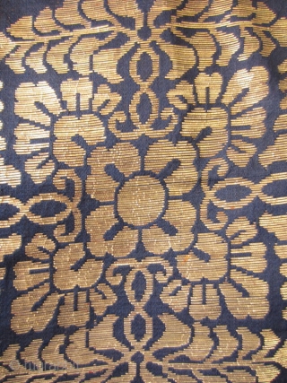 Japanese Antique Large Buddhist Textile Cover

Beautiful antique Japanese large covering originally used in a Buddhist temple. Three deep blue silk panels sewn together and woven with gold in design of 18 chrysanthemums  ...