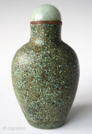 Antique Chinese Turquoise Encrusted Snuff Bottle

Antique Chinese snuff bottle of a flattened oval form with recessed foot, encrusted with finely crushed turquoise. The stopper has a jadeite lid with bright apple green  ...