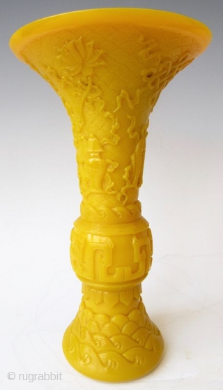 Antique Chinese Pair of Yellow Peking Glass Gu Vases

An elegant pair of Chinese monochrome yellow peking glass gu vases with relief carvings of waves, archaic scrolling serpents, one vase with a pair  ...